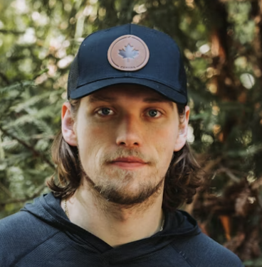 Man wearing a cap standing outdoors